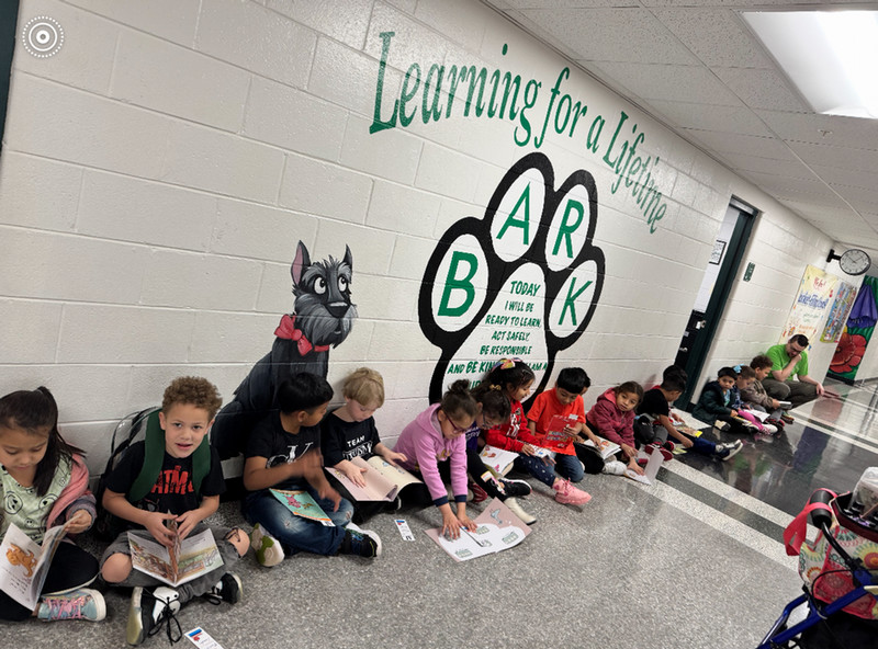 Children reading in school hallway
