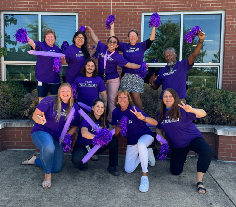 staff wearing purple shirts